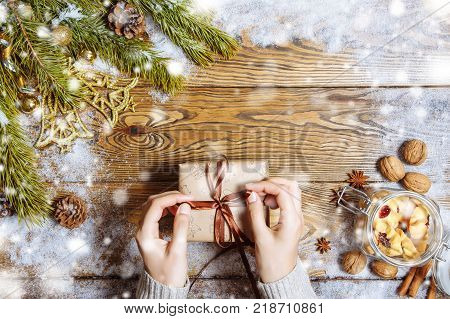 Female hands opening gift box. Christmas background. Copy space