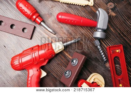 A Set Of Children's Toy Tools On A Wooden Background