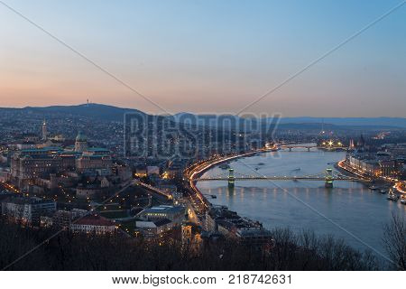 Historic Royal Palace - Buda Castle on night in light the background Chain Bridge in Budapest Hungary