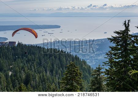 Tandem paragliding flight with blue glide and nice fluffy thermal clouds in background. Outdoor and extreme sports theme.