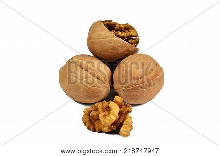 a few walnuts in a scrap and a kernel on a white background