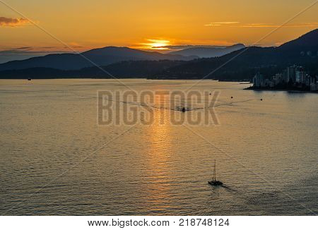 Sunset with Sea and Mountain View. Lions Gate Bridge Sunset and evening in Vancouver Canada.