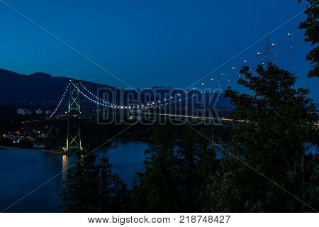 Lions Gate Bridge Sunset and evening of the beautiful town on Pacific Ocean in Vancouver Canada.