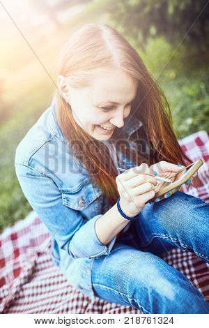 girl sitting in the sunny park. picnik