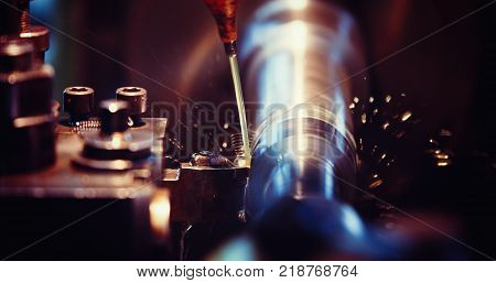 sparks flying while machine griding and finishing metal in factory