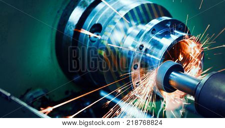 sparks flying while machine griding and finishing metal in factory