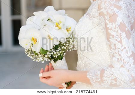 close-up of a bride holding a wedding bouquet. The concept of a wedding festival and a happy life