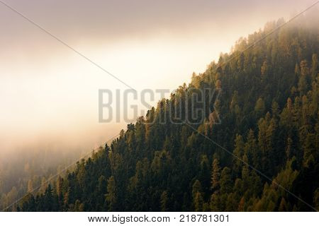 Sunrise over mountains and lake with canoeist