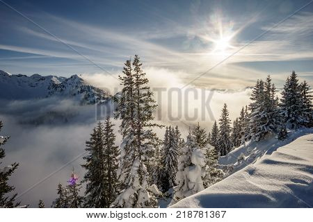 Sunrise over mountains and lake with canoeist