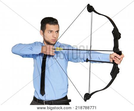 Young businessman practicing archery on white background