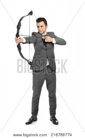 Young businessman practicing archery on white background