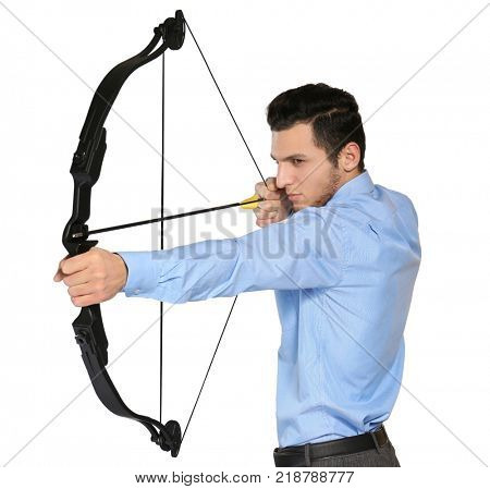 Young businessman practicing archery on white background