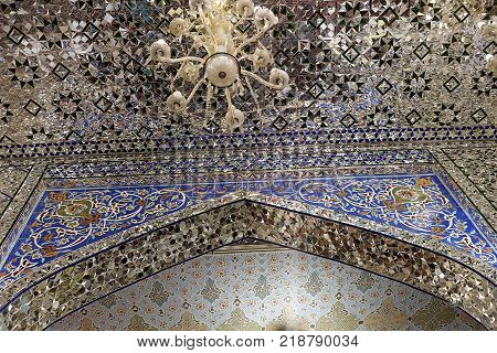 Prayer hall of Sahhzade Fazel Holy Shrine decorative Persian tiles detail of tile work on ceiling and wall in mosque Yazd Iran.