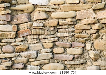 Masonry Walls Made Of Natural Sea Boulders, Closeup, Concept Of Ancient Buildings