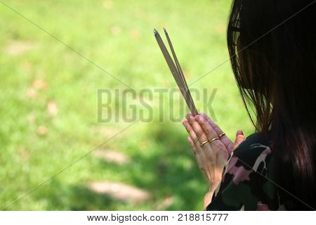 Asian people pay respect to shrine of the household god or spirit worship Incense and firecrackers