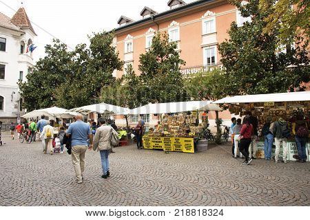 Italian people and foreigner travellers walking travel and shopping at handmade and organic food street market at Meran city on September 2 2017 in Merano Italy