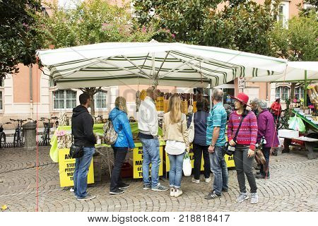 Italian people and foreigner travellers walking travel and shopping at handmade and organic food street market at Meran city on September 2 2017 in Merano Italy