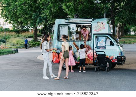 Vienna, Austria - August 15, 2017: Unidentified people buying ice creams at food truck in Karlsplatz.