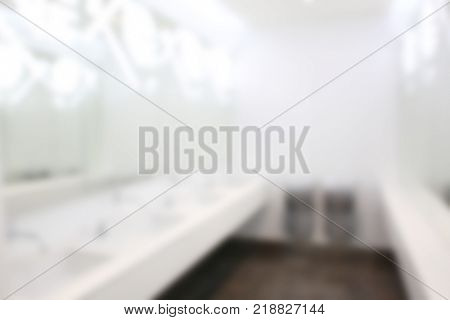 Modern sinks with mirrors in public toilet, blurred view