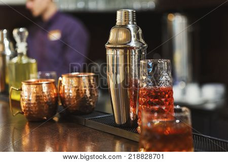 Creative exotic alcohol cocktails assortments on bar counter background, refreshing drinks in public place, copy space
