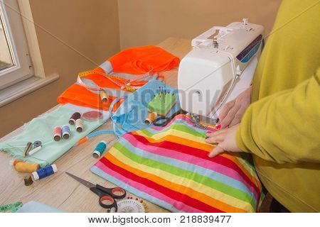 Tailoring of natural cotton. Woman tailors sewing fabric. Tailor Woman fashion designer working at studio