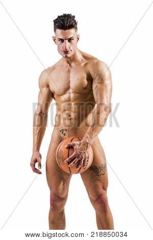 Totally naked male bodybuilder hiding genitals with basketball ball, looking at camera smiling, isolated on white background.