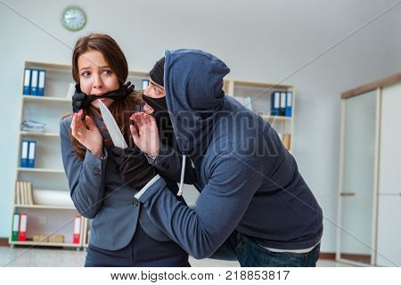 Criminal taking businesswoman as hostage in office