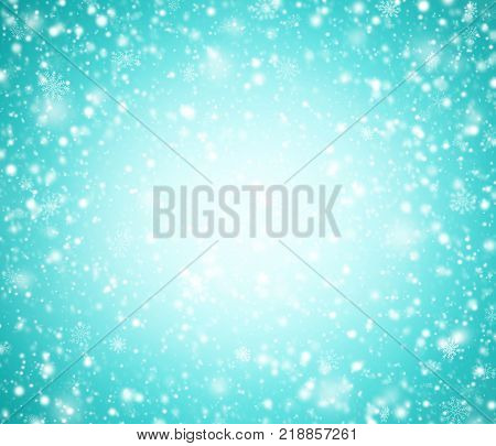 Cyan winter background with snowflakes and light.