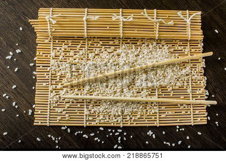 sushi-rug chopsticks and rice lie on the table