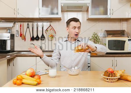 Perturbed Young Business Man In Suit, Shirt, Having Breakfast, Sitting At Table With Tablet, Spreadi