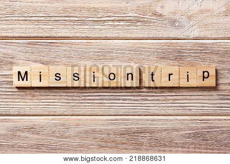 Mission Trip word written on wood block. Mission Trip text on table concept.