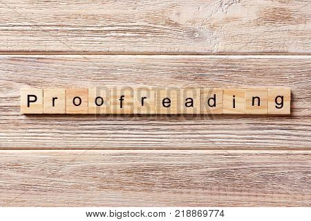 proofreading word written on wood block. proofreading text on table concept.