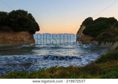 Rocks on the beach in the morning sunrise Corfu in Greece