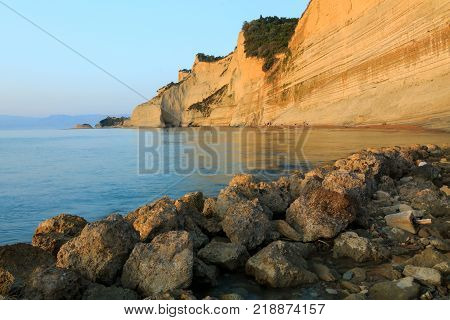 Rocks on the beach in the sunset on Corfu in Greece