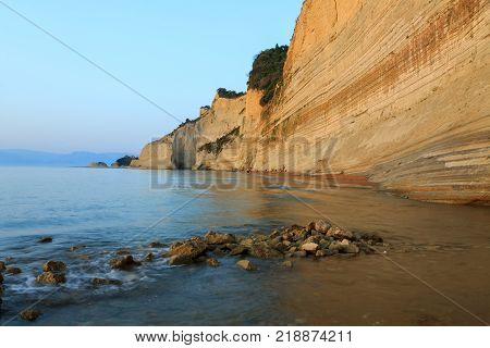 Rocks on the beach in the sunset on Corfu in Greece