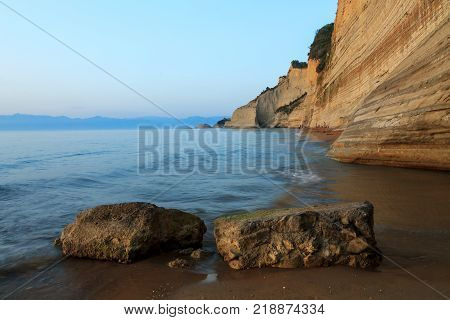 Rocks on the beach in the sunset on Corfu in Greece
