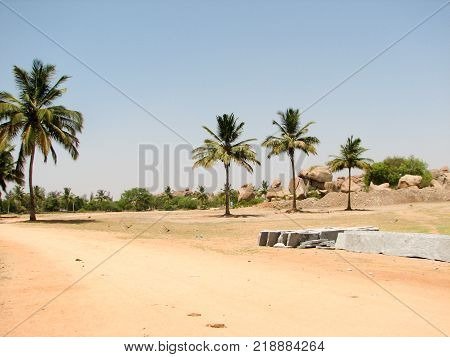 View of ancient ruins on Hemakuta hill in Hampi, Karnataka, India. Landscape with unique mountain formation with amazing stones, tropical nature and temple. UNESCO World Heritage Site