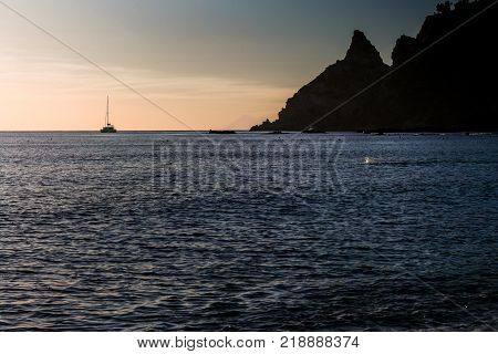 the ship far on the horizon near the cliffs