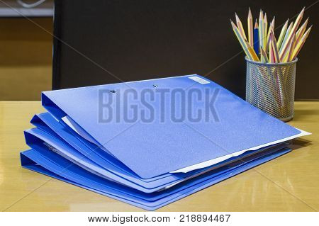 file folder with documents and document retention and pencil of contracts in the meeting room, business concept