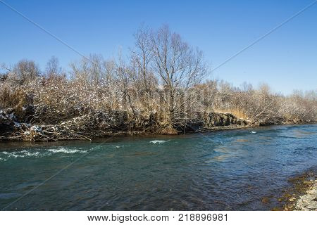 River in Winter. Rapids of Stormy River. Winter Landscape
