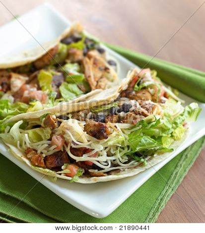 two soft shell chicken tacos shot with selective focus