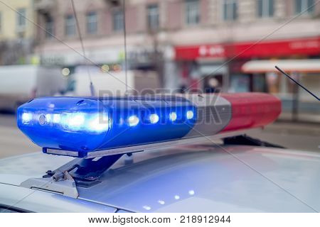 The roof-mounted activated lightbar of police vehicle