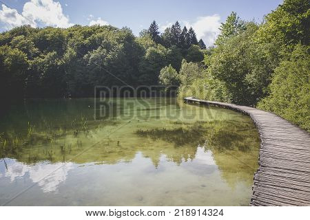 Landscape With Wooden Track Over The Water At  