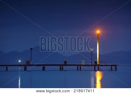 night shot of the marina with pier and lighthouse. Turkey, Gocek.