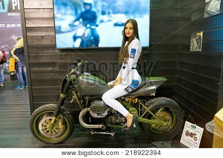 MILAN, ITALY - NOVEMBER 11, 2017: a model poses for the visitors during the EICMA 2017 - 75th International Motorcycle Exhibition.