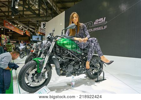 MILAN, ITALY - NOVEMBER 11, 2017: a model poses for the visitors during the EICMA 2017 - 75th International Motorcycle Exhibition.