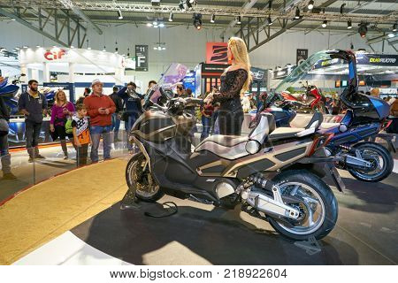MILAN, ITALY - NOVEMBER 11, 2017: a model poses for the visitors during the EICMA 2017 - 75th International Motorcycle Exhibition.