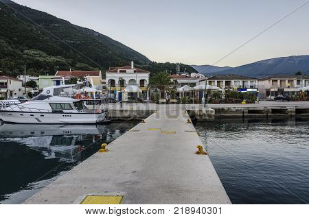Port of Sami one of its docks then the port facilities and finally the hills of the island of Kefalonia on the Ionian Sea Greece