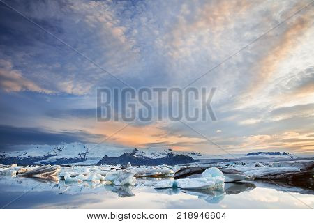 Floating icebergs in Jokulsarlon Glacier Lagoon during sunset