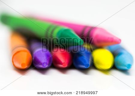 Colorful Crayons on a white background with selective blur